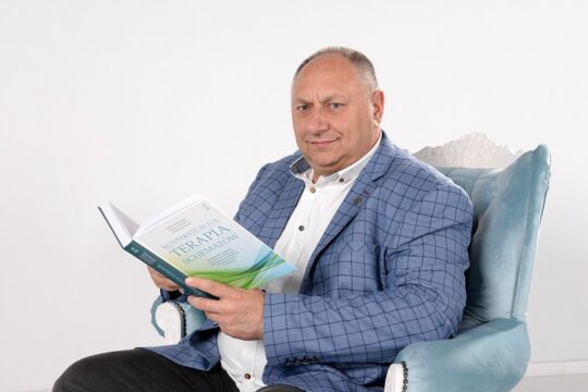 Terapeuta trzymający książkę „Terapia schematów”